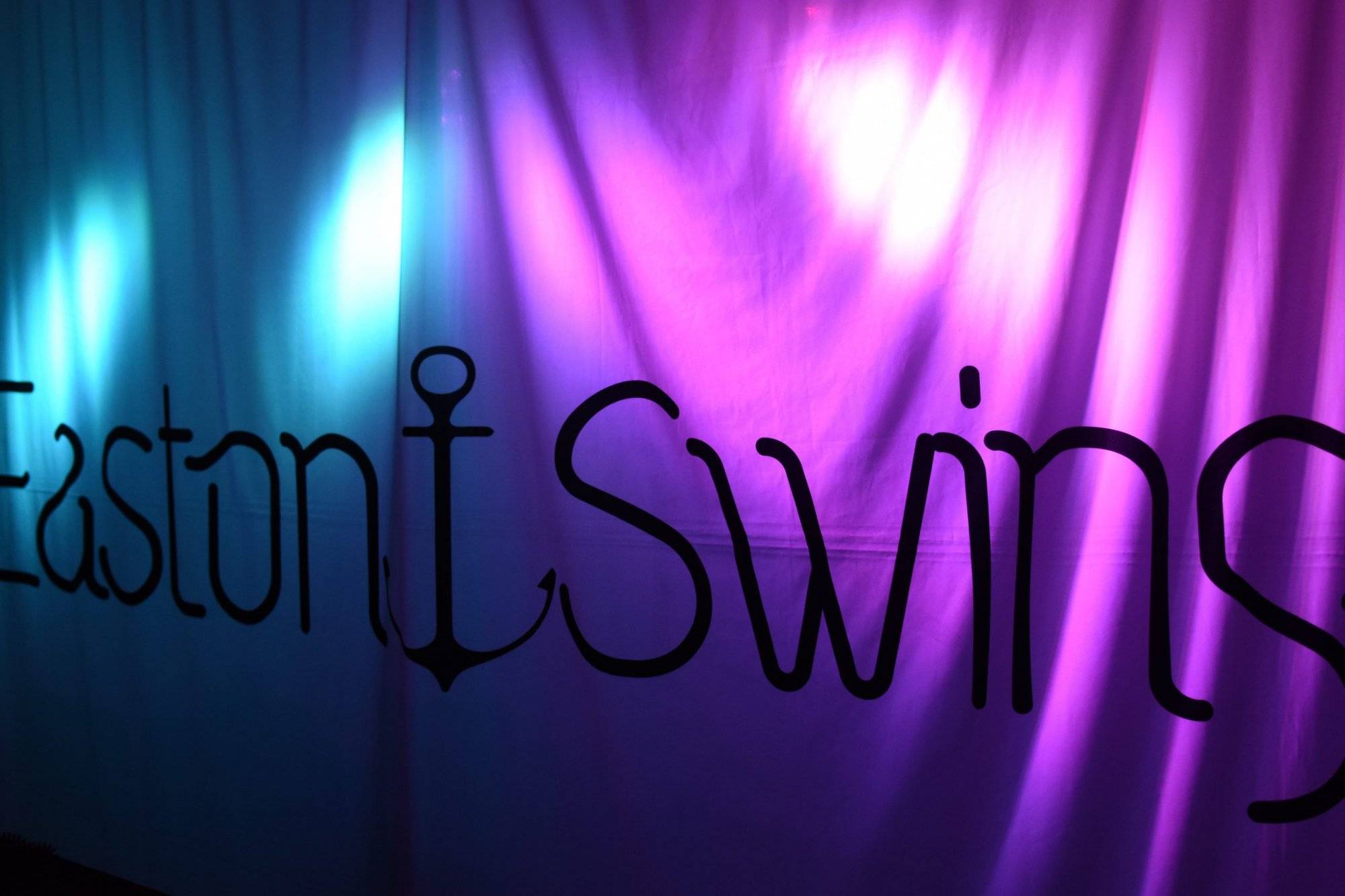 West coast swing freestyle, A back lit cloth backdrop displaying company logo for EastonSwing in Black